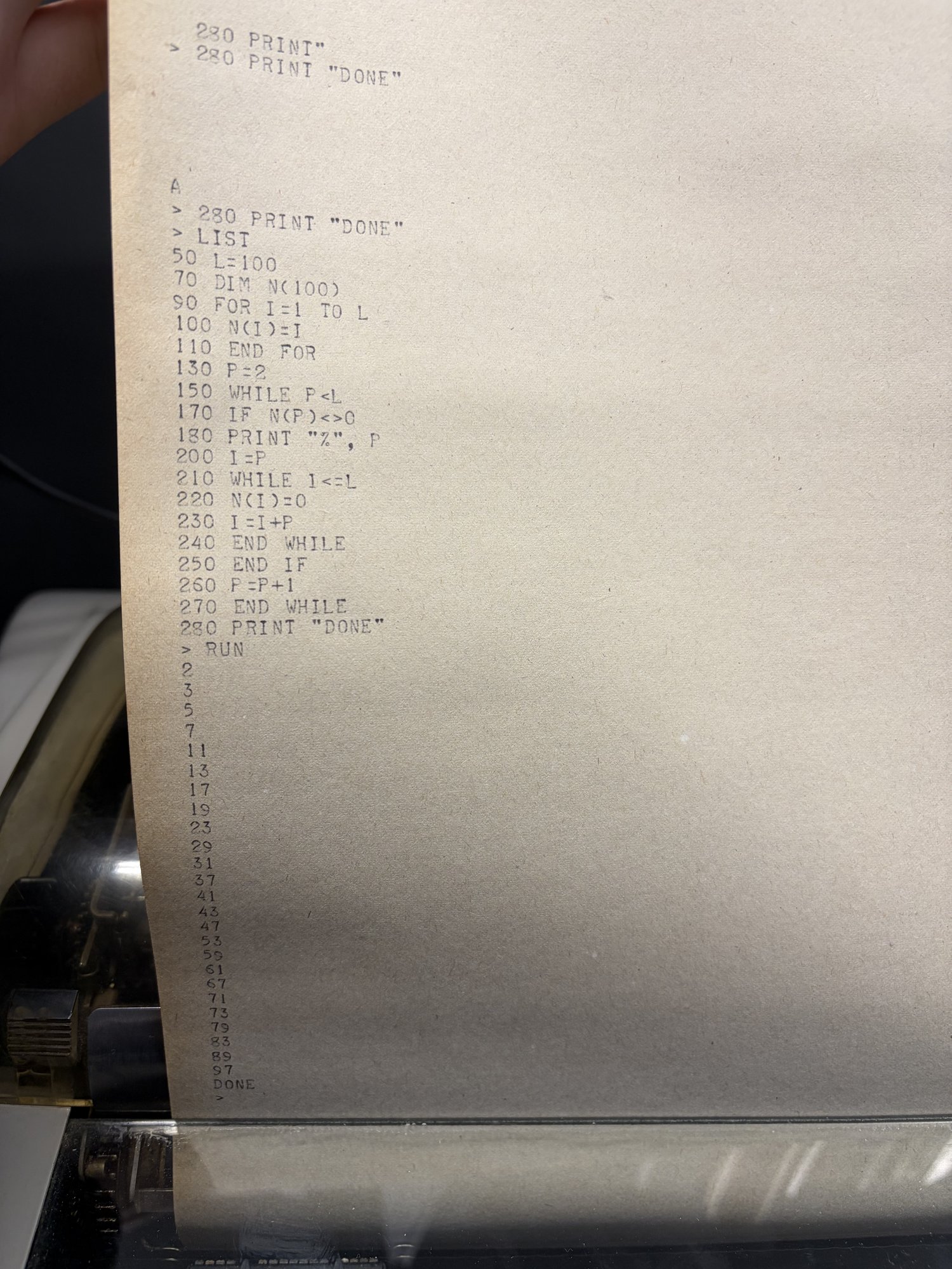 A BASIC prime sieve listing and its output on the teletype.