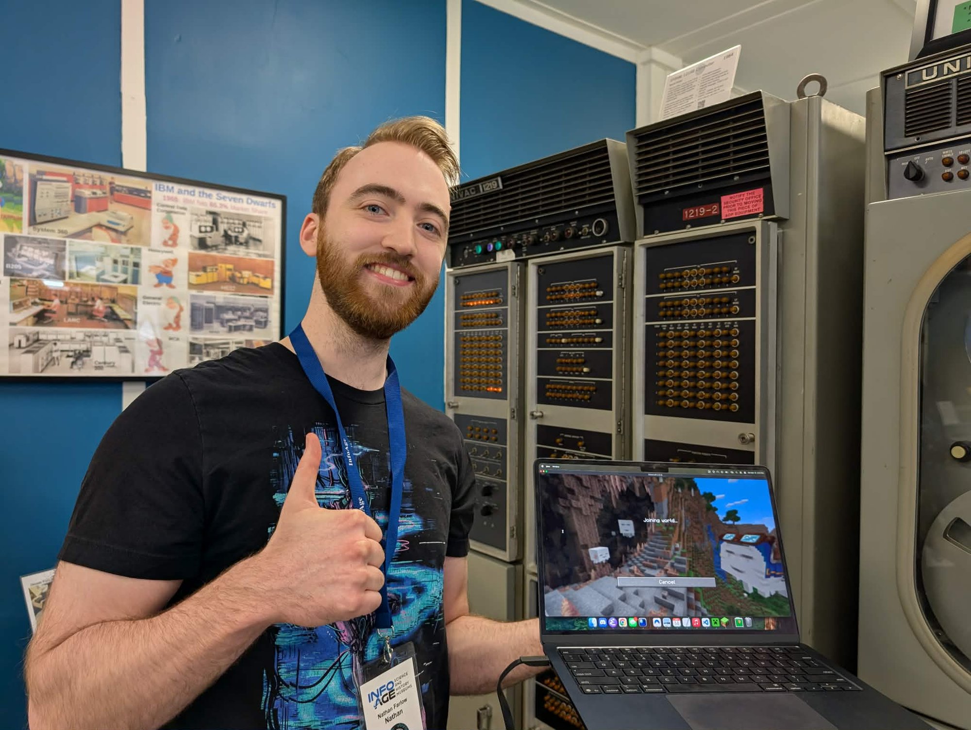 Nathan standing next to the UNIVAC 1219B with a laptop running Minecraft.