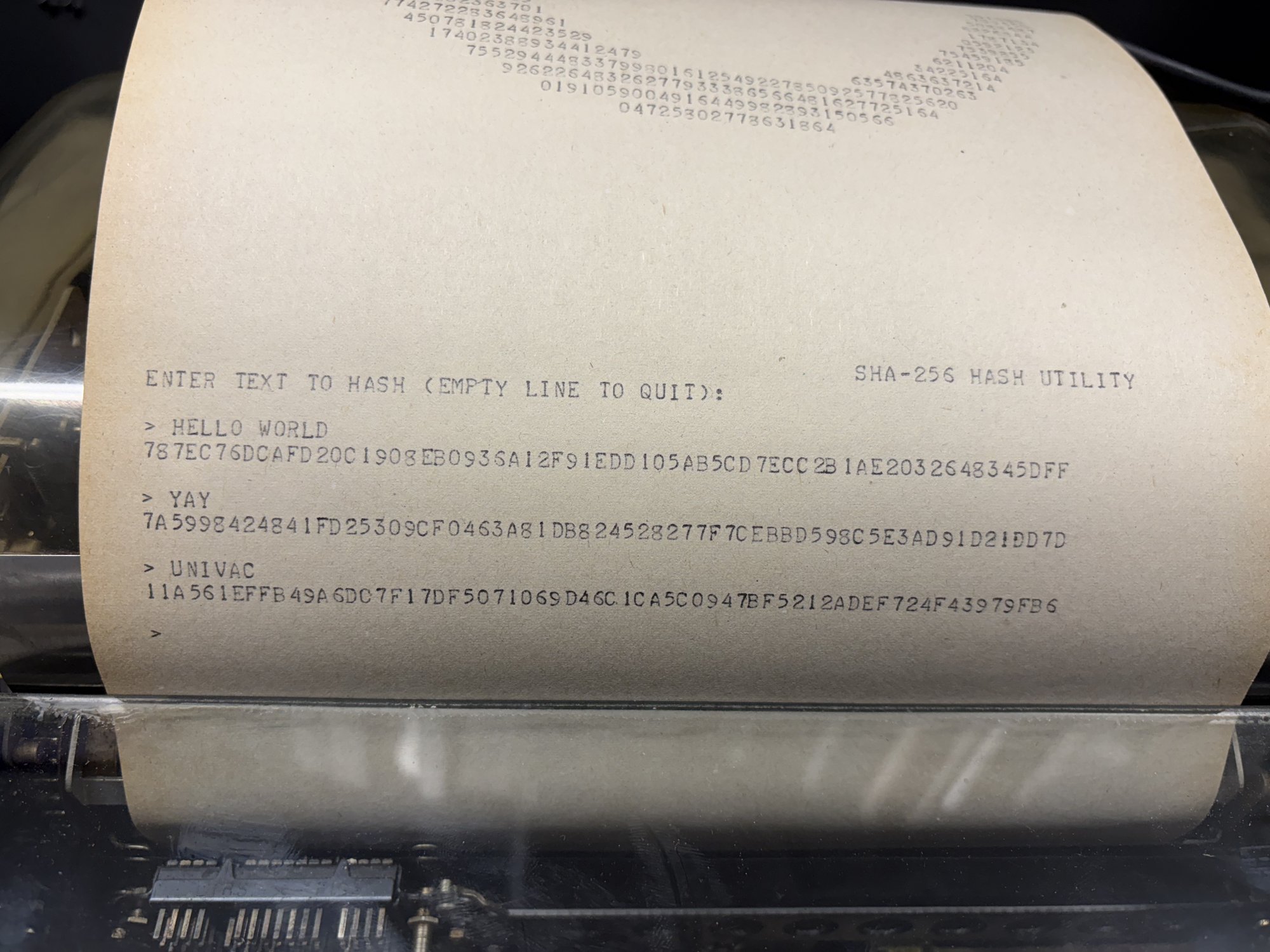 Teletype paper showing the SHA-256 utility hashing three inputs.